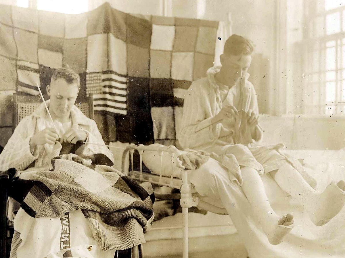 Recovering soldiers learning needlework in an army hospital, around 1918